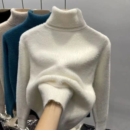 White turtleneck sweater on a mannequin with a gray background