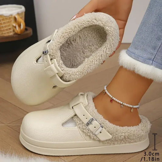 White slip-on shoes with fuzzy lining held by a person on a wooden floor.