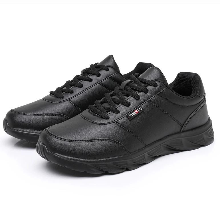 Pair of black sneakers on a white background