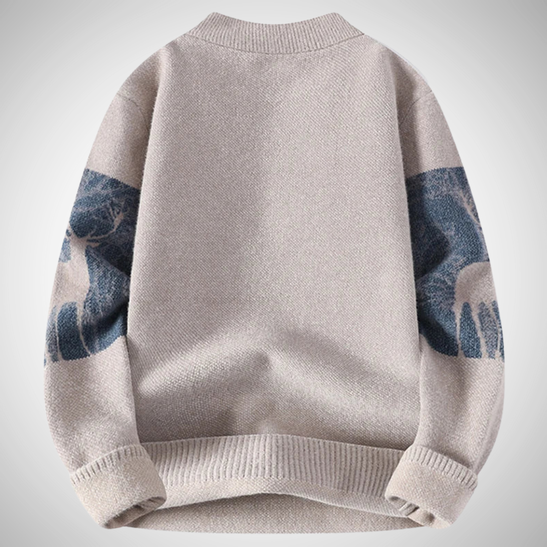 Gray sweater with blue arm patches on a light gray background