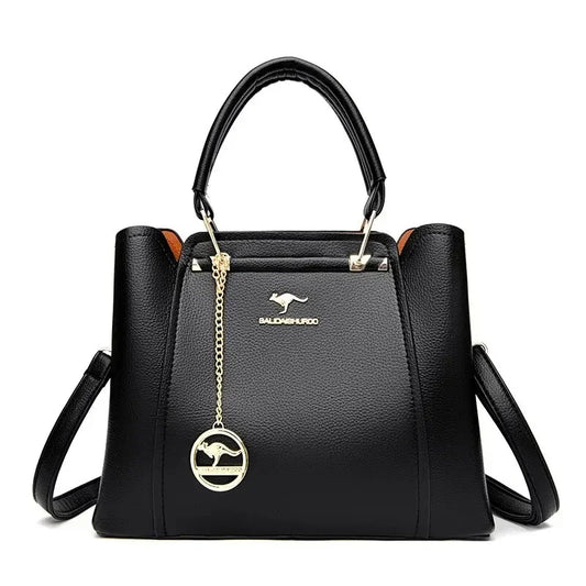 Black handbag with a gold pendant on a white background