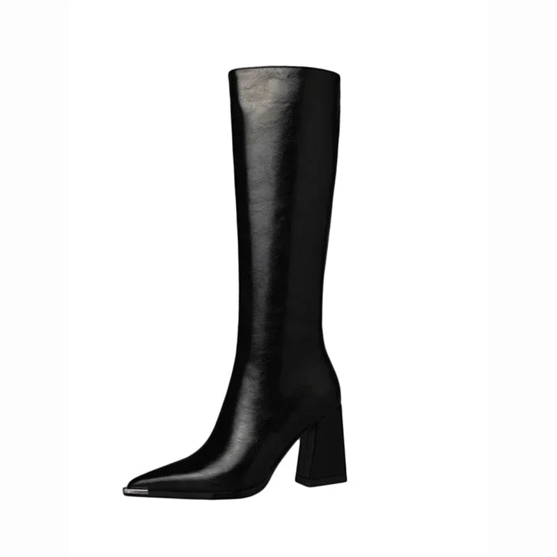 A single black leather knee-high boot with a pointed toe and a chunky block heel, shown in profile against a plain white background.