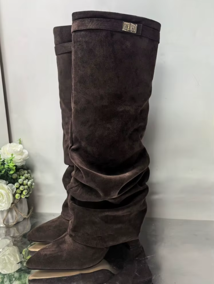 Beige knee-high boots worn with a brown skirt on a white background