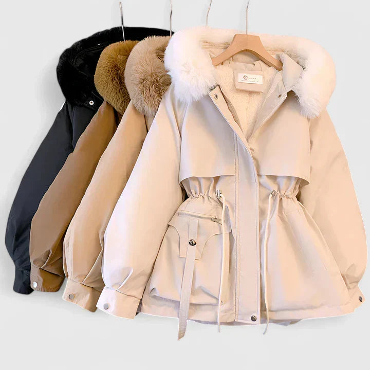 Beige winter coat with fur-lined hood on a hanger against a white background