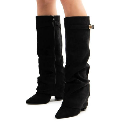 Black knee-high boots with a gold buckle on a white background