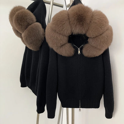 Black sweater with brown fur collar on a mannequin against a white background