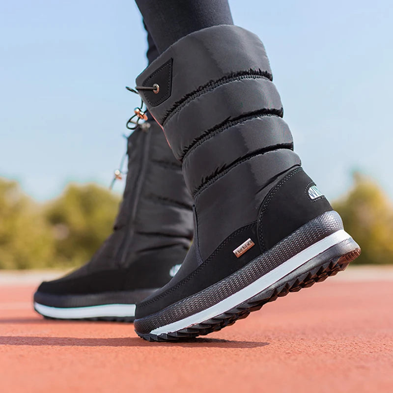 Black winter boots with white soles on a blurred outdoor background