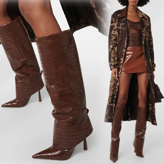 Brown knee-high boots with a person wearing a coat and skirt in the background.