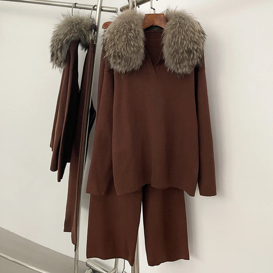 Brown outfit with fur collar on a rack against a white wall