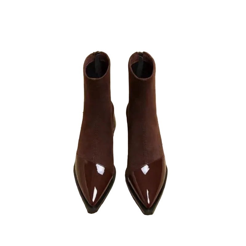 Brown pointed-toe boots on a newspaper background