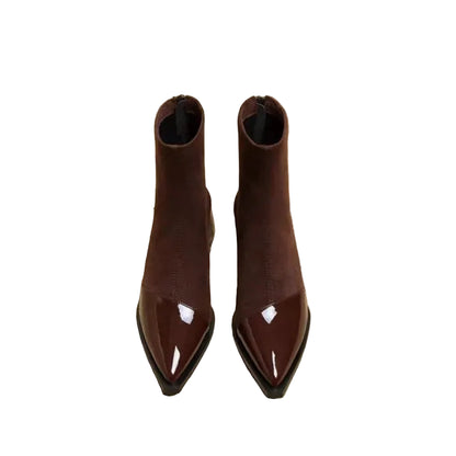Brown pointed-toe boots on a newspaper background
