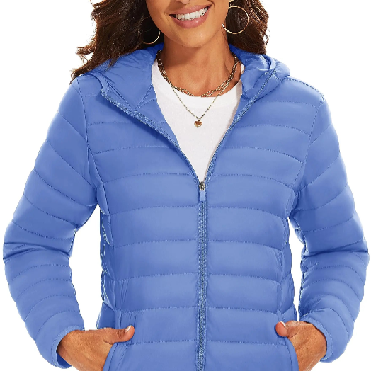 Woman wearing a blue puffer jacket on a white back