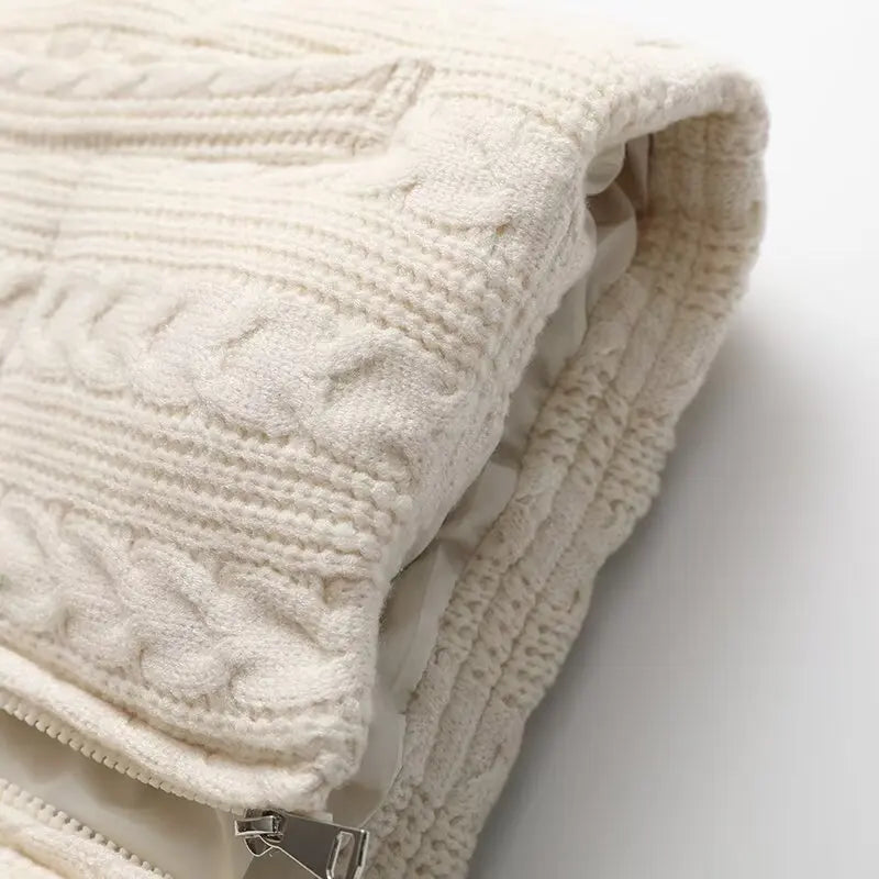 Close-up of a textured beige blanket on a white background