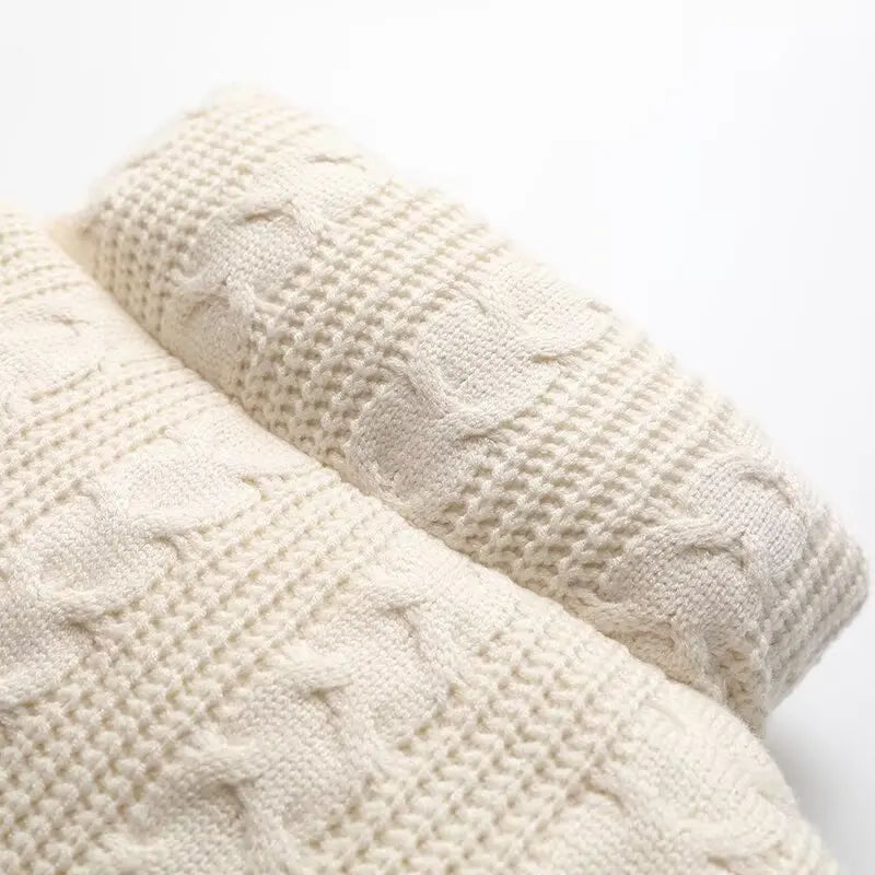Close-up of two cream-colored textured pillows on a white background