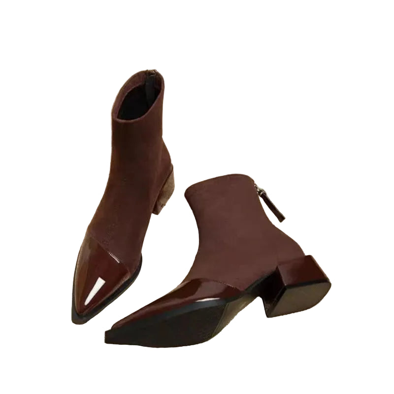 Pair of brown ankle boots on a newspaper background