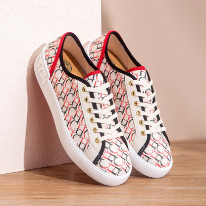 Pair of patterned sneakers on a wooden surface with a neutral background