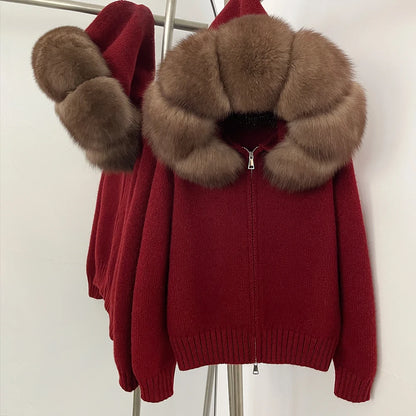 Red sweater with brown fur collar and cuffs on a mannequin against a white background