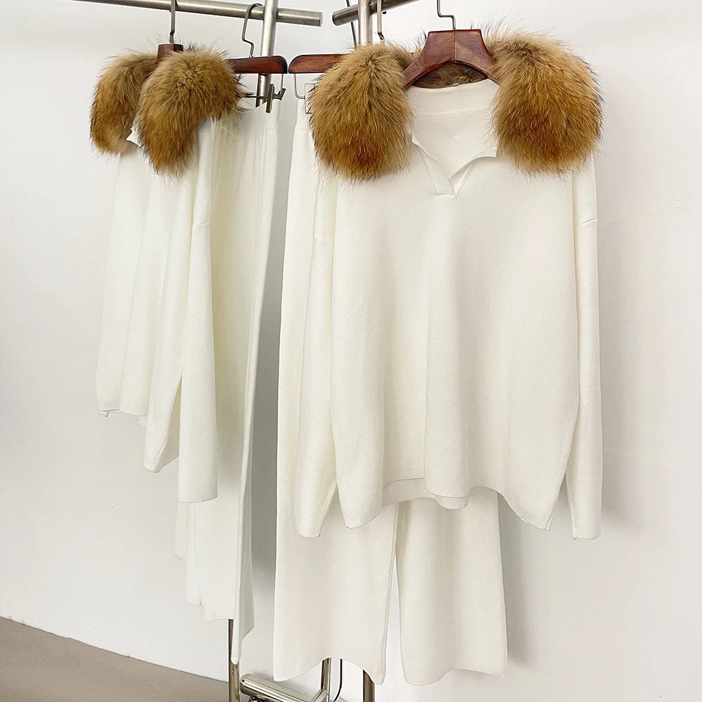 White outfit with fur-lined hood on hangers against a white background