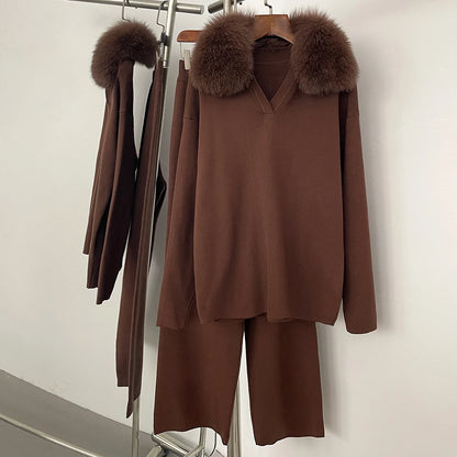 Brown outfit with fur collar on a rack against a white wall
