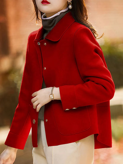 Person wearing a red coat with a blurred background