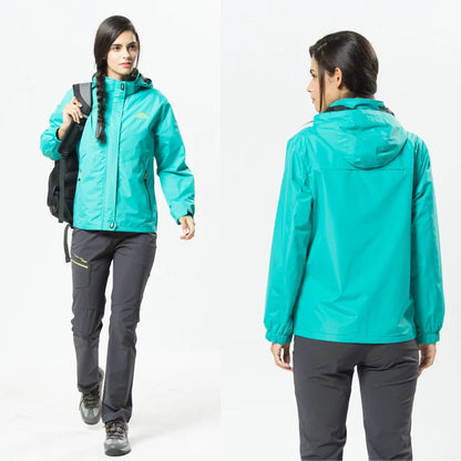Person wearing a turquoise jacket and gray pants, standing against a white background.