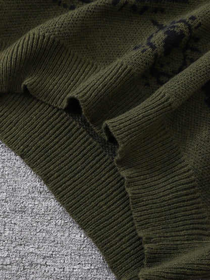 Close-up of a dark green knitted sweater on a textured surface