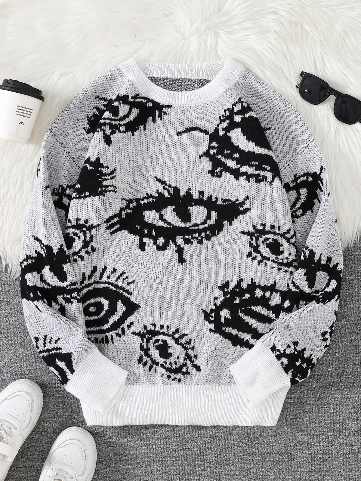 Sweater with eye pattern on a white surface