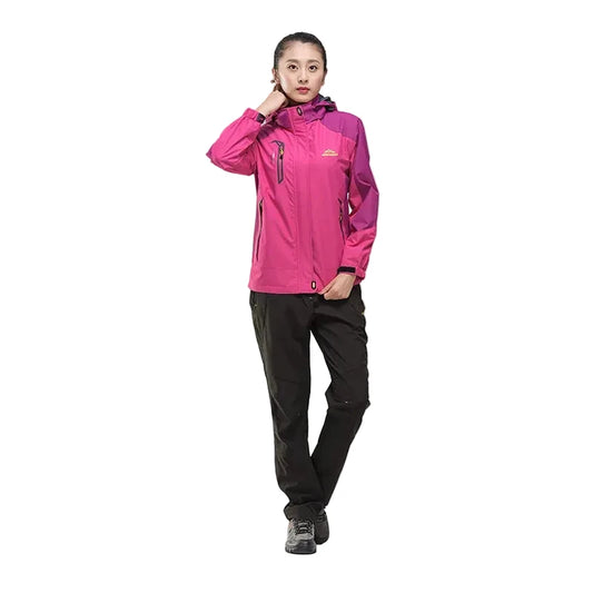Person wearing a pink jacket and black pants on a white background