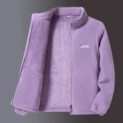 A light purple fleece zip-up jacket with a plush lining, shown open against a dark gray gradient background. A small white and red FILA logo is visible on the left chest.