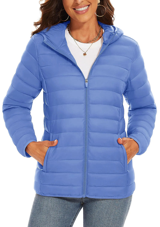 Woman wearing a blue puffer jacket on a white background