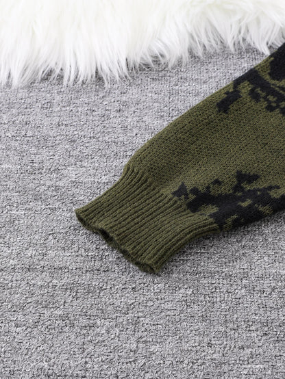 Green knitted sleeve with black pattern on a gray surface