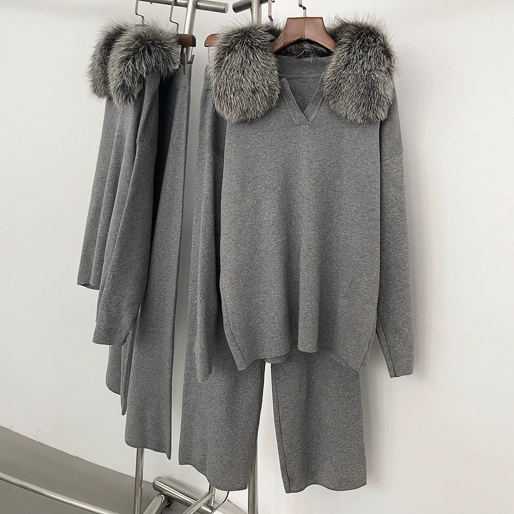 Gray outfit with fur-lined hood on a rack against a white background