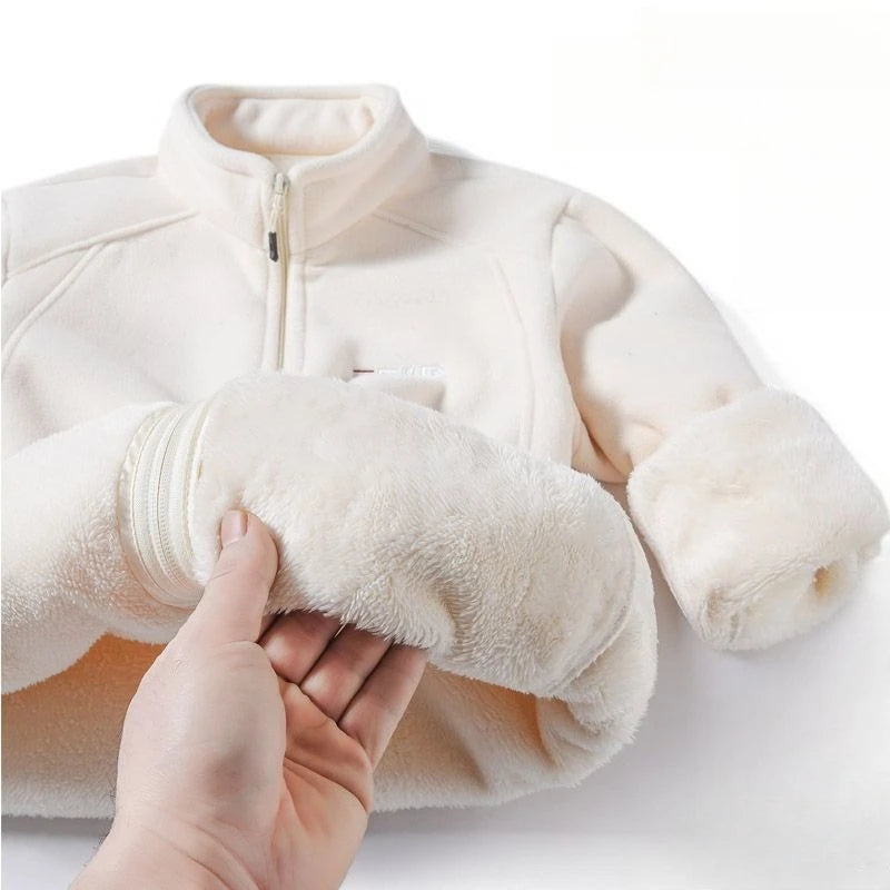 White fleece jacket with a plush toy held by a hand on a white background