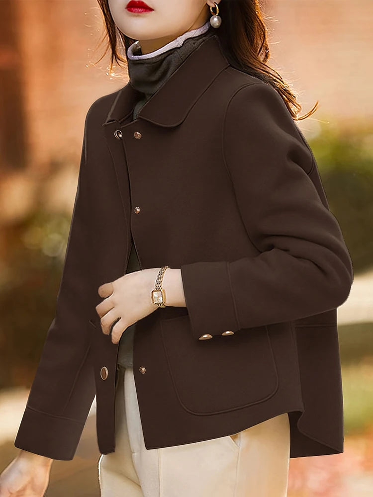 Person wearing a brown coat with a blurred background