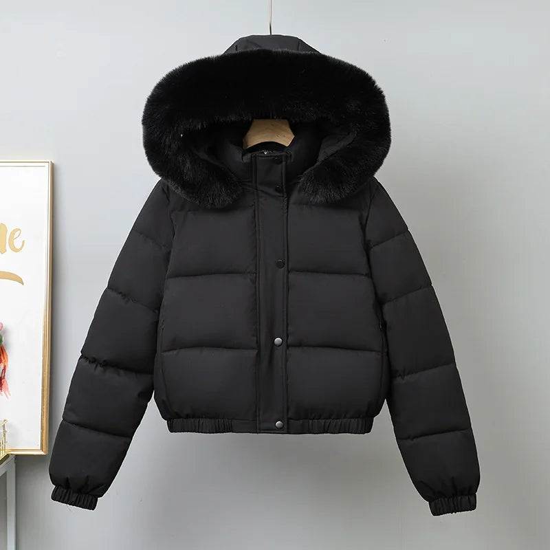 Black puffer jacket with fur hood on a mannequin against a light gray background