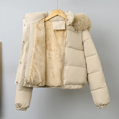Beige puffer jacket with fur hood on a hanger against a gray background