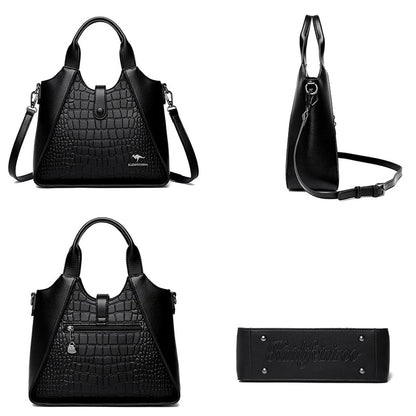 Black handbag with crocodile texture and matching wallet on a white background