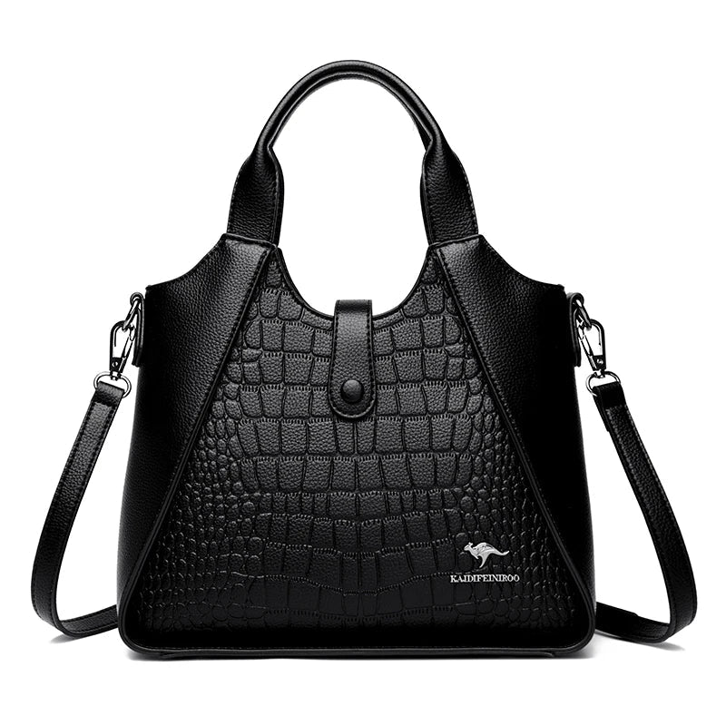 Black handbag with crocodile texture on a white background