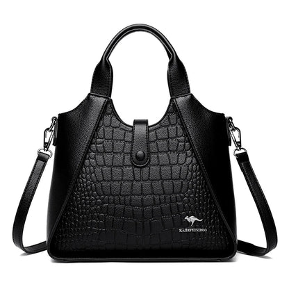 Black handbag with crocodile texture on a white background