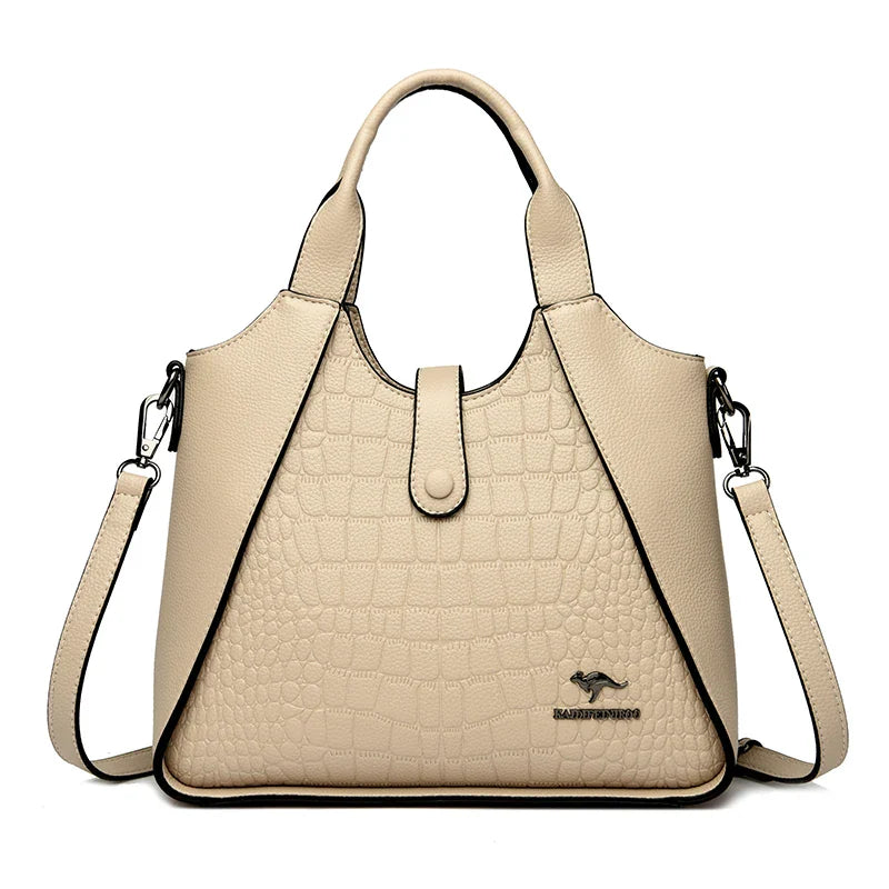 Beige handbag with a crocodile texture on a white background