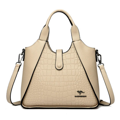 Beige handbag with a crocodile texture on a white background
