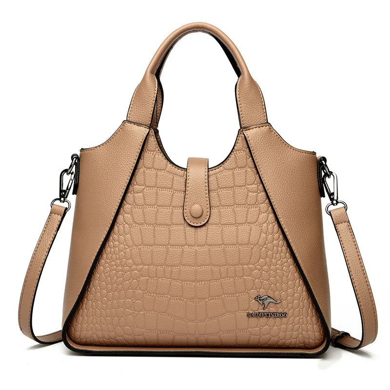 Beige handbag with crocodile texture on a white background