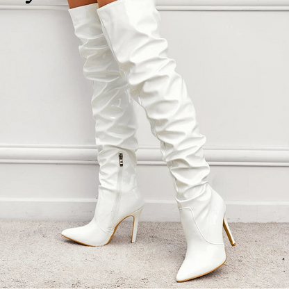 White knee-high boots with high heels on a light background