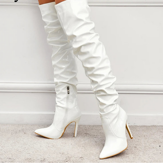 White knee-high boots with high heels on a light background