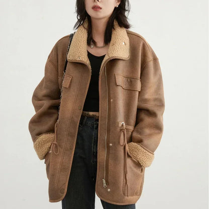 Woman wearing a brown shearling jacket on a white background