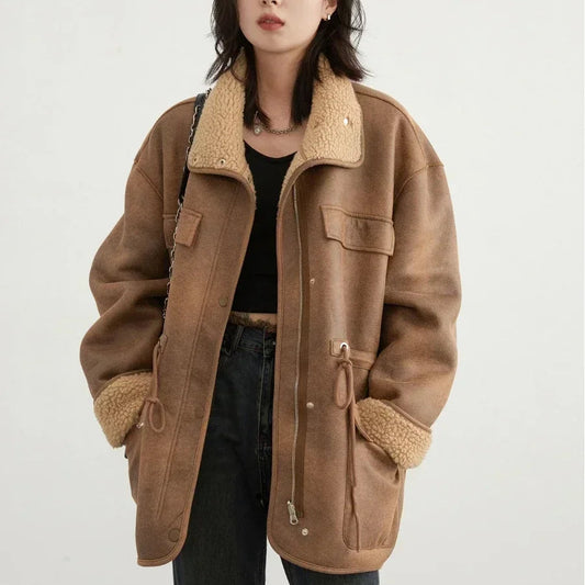 Woman wearing a brown shearling jacket on a white background