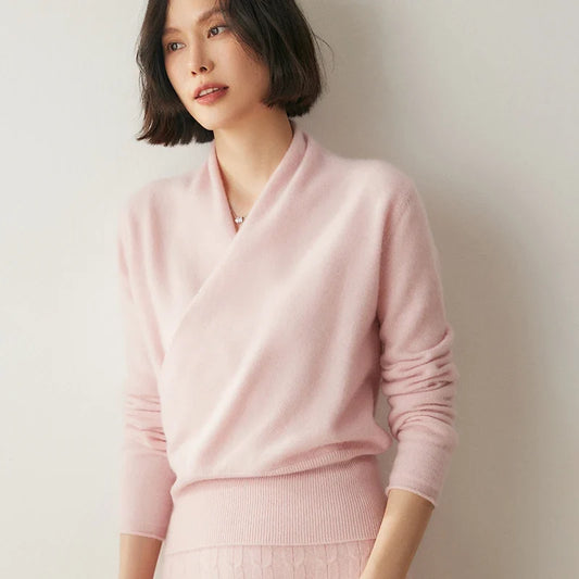 Woman wearing a pink sweater against a plain background