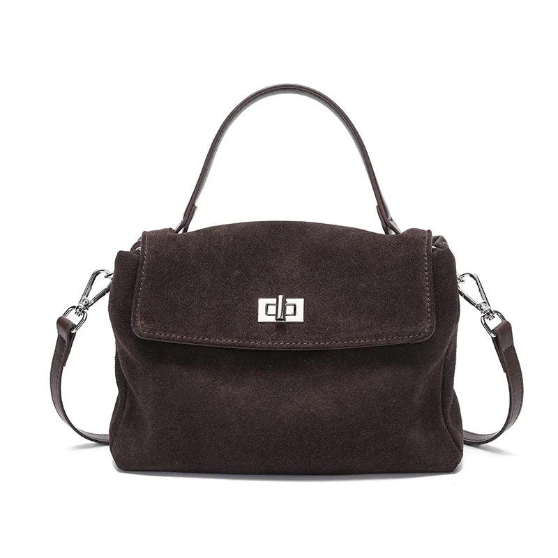 Brown suede handbag with a visible brand logo on a white background