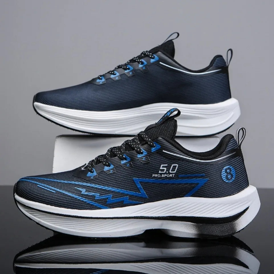 Pair of black and blue running shoes on a reflective surface with a gray background