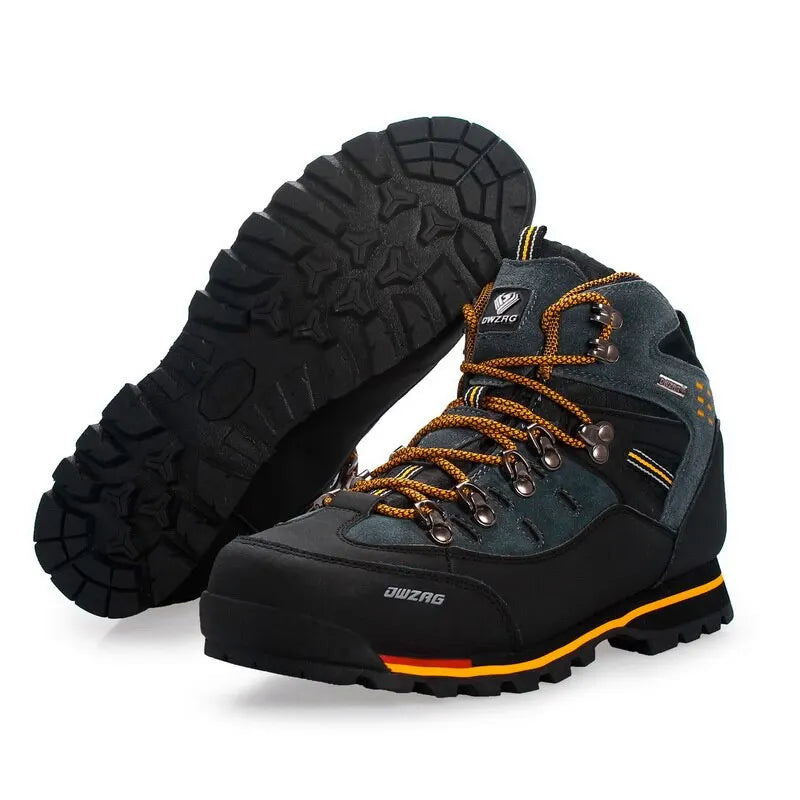 Pair of black and gray hiking boots with orange accents on a white background